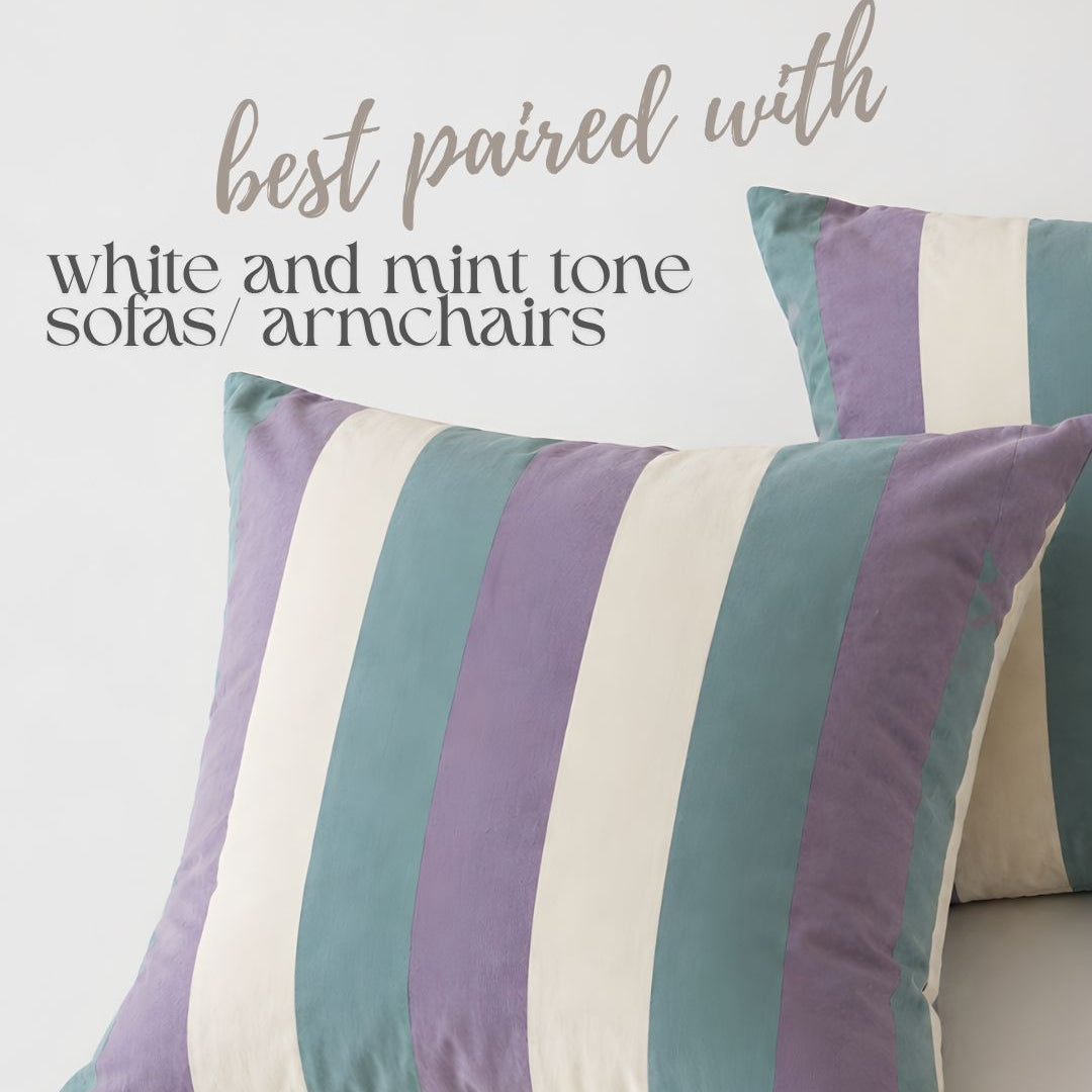 Striped pillow with purple, green, and beige colors on a white background