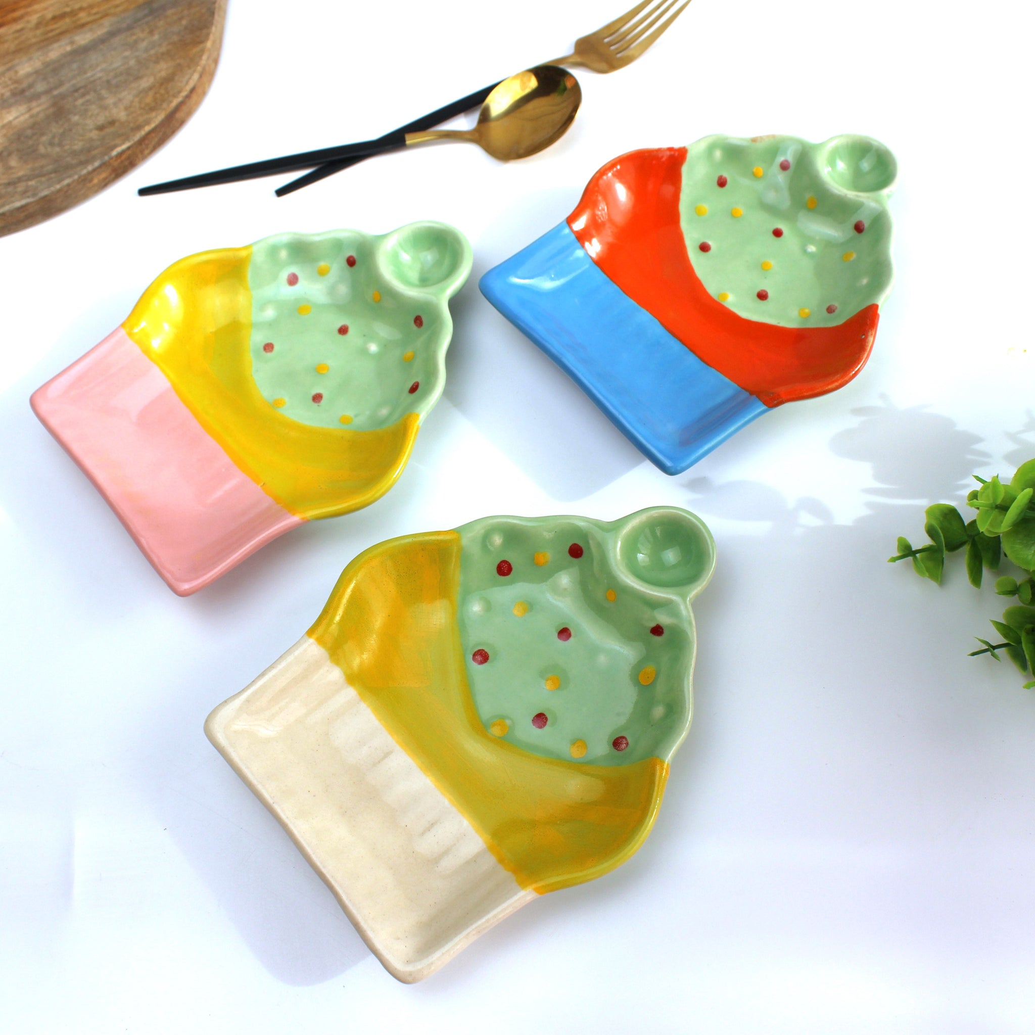 Colorful ceramic plates shaped like ice cream cones on a white background