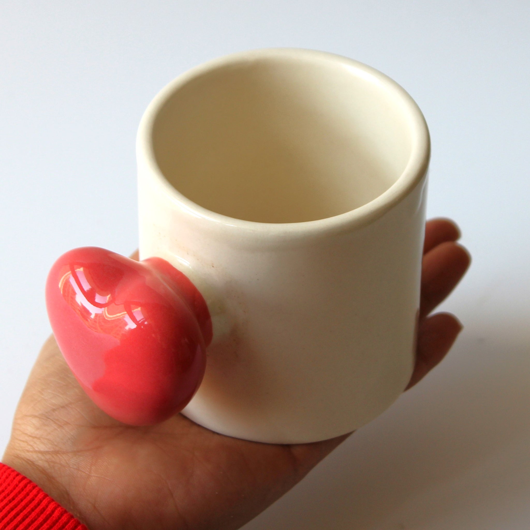 ceramic mug held in hand- cute design pretty heart coffee mugs 