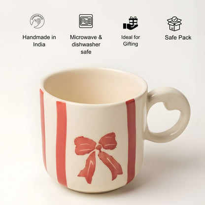 White mug with red bow design on a white background, featuring icons and text about product features.